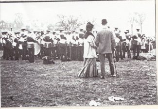 Spectators watch the band between races