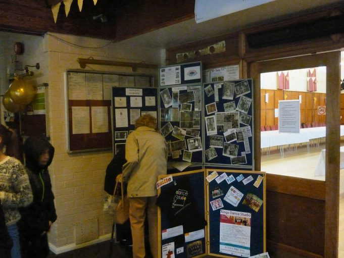 Mrs Gant, who used to be one of the avid fund raisers, both before and after the hall was built, looks at some of her press cuttings on the board | Jo Cullen
