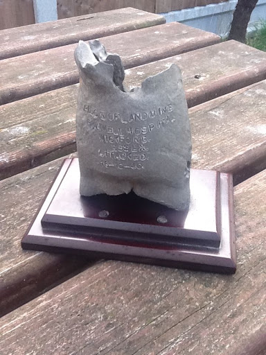 Here is a photograph of the mounted piece of landmine that was given to Trevor Williams by Miss McMullen. It was made by hospital engineer Mr. Flack from the left over pieces of mine he recovered to make the new piston for the blood transfusion unit.