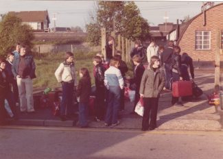 The attached photo of the building (hut) in Station Avenue was taken in 1979, players from Wickford Town FC junior section are waiting for a coach to take them to Essen in Germany for an exchange visit. Wickford Town teams used the building for training sessions, social evenings (darts, pool, etc) and club presentations. The building was owned by John Holman Insurance, their office address was John Holman House, 34 The Broadway. The building, next to Cowling and Payne, is still there but the offices are occupied by a different company and just known as 34 The Broadway. I’m looking for better photos of the building both inside and out and any memories of ‘then’ children and adults using it or anyone who worked from the insurance company. 